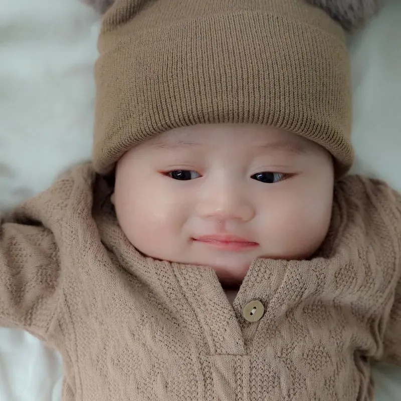 Baby wearing a Nozaad set, sized for three to six months