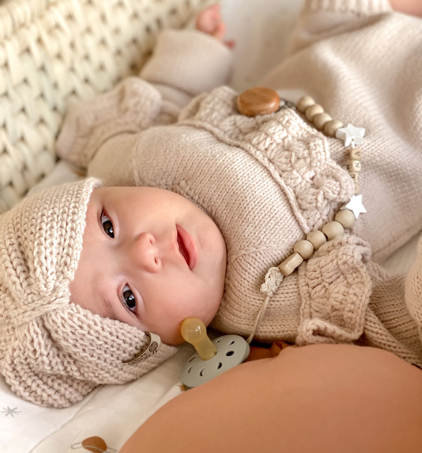 Baby in soft organic cotton in a sunlit nursery